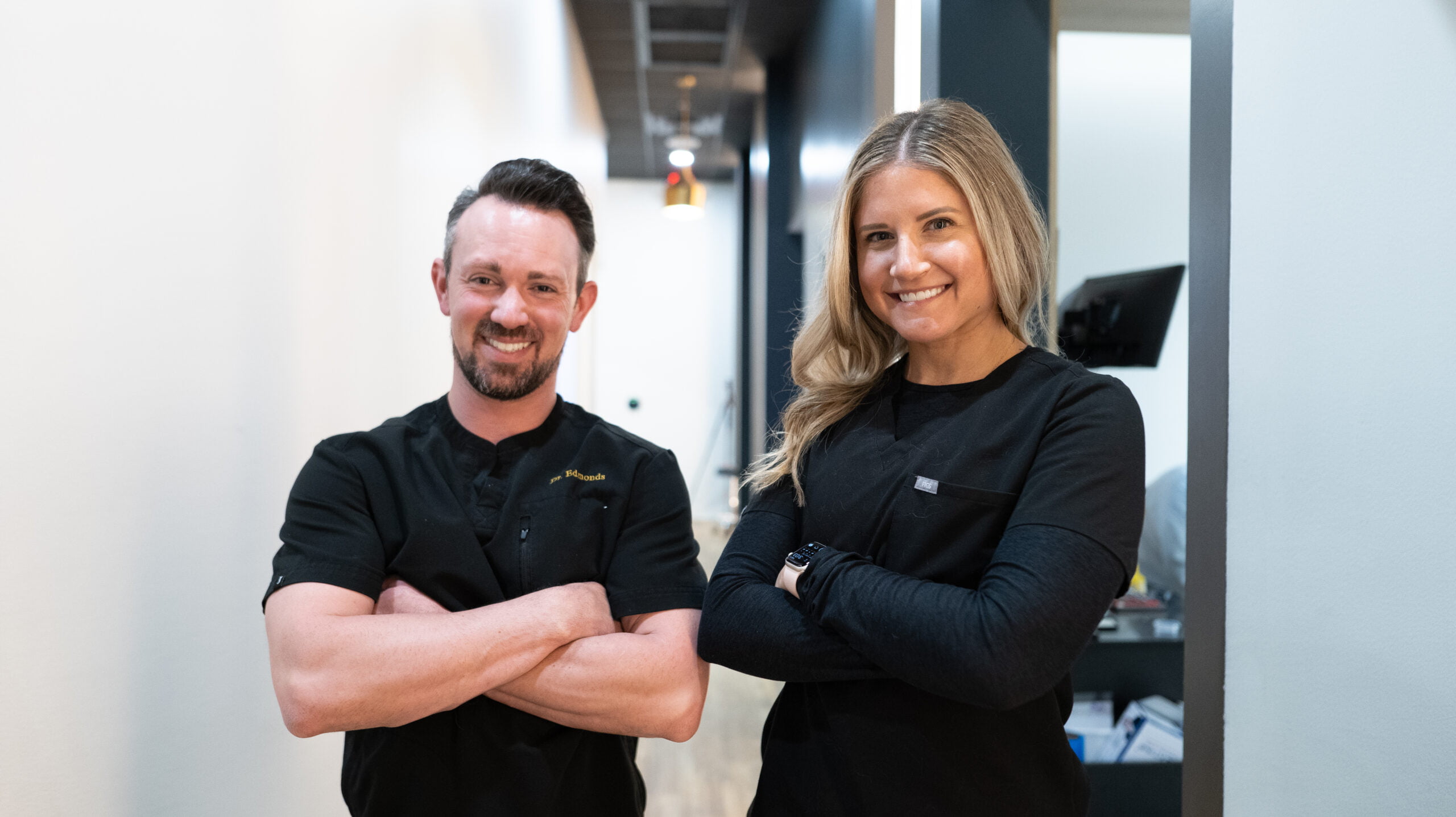 Dr. Andrew Edmonds and Dr. Brenna Sura striking a smile pose and arms crossed - Dentist Georgetown TX Dr. Andrew Edmonds and Dr. Brenna Sura striking a smile pose and arms crossed - Dentist Georgetown TX