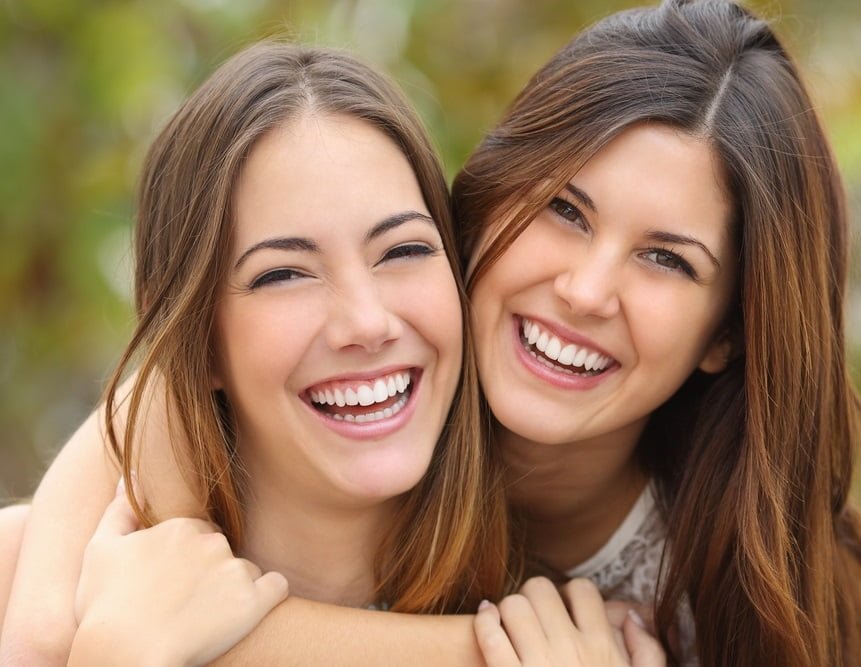Portrait of two happy women with perfect teeth - Cosmetic Dentistry in Georgetown, TX