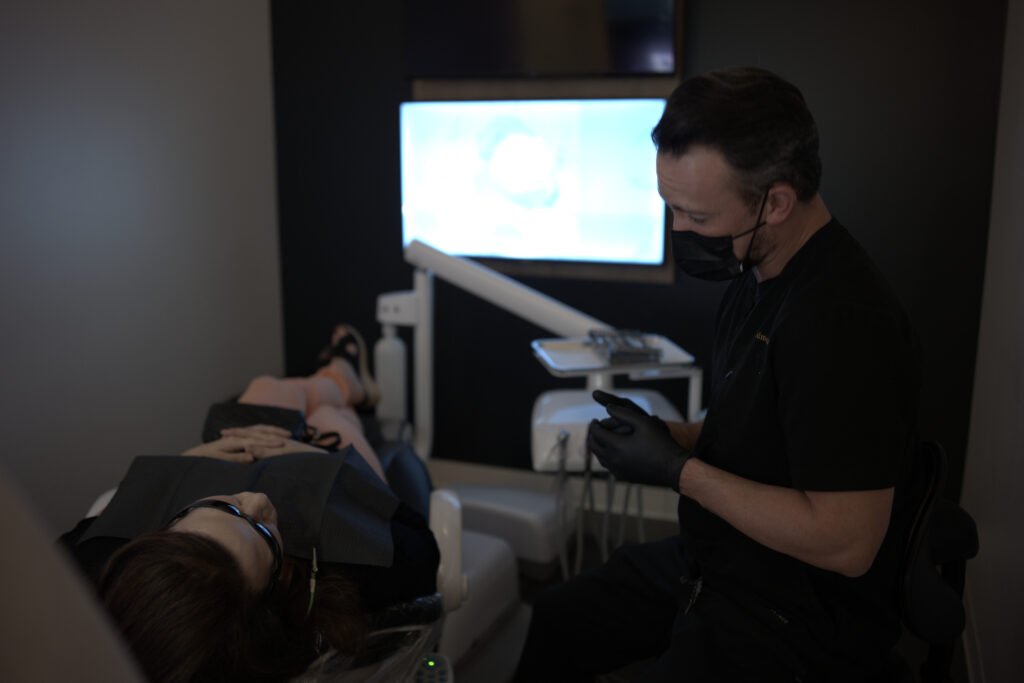 Dr. Andrew Edmonds explaining a dental result to a patient - Dentist Georgetown TX Dr. Andrew Edmonds explaining a dental result to a patient - Dentist Georgetown TX