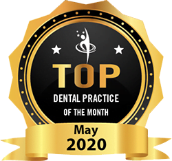 An award badge labeled "Top Dental Practice of the Month" for May 2020, featuring a gold ribbon and black center with white stars - Dentist Georgetown TX An award badge labeled "Top Dental Practice of the Month" for May 2020, featuring a gold ribbon and black center with white stars - Dentist Georgetown TX