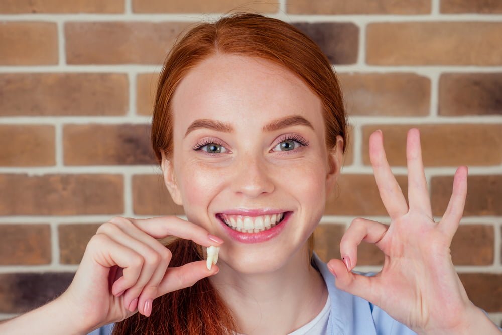Woman holding a tooth model - Dental Crown in Georgetown Woman holding a tooth model - Dental Crown in Georgetown