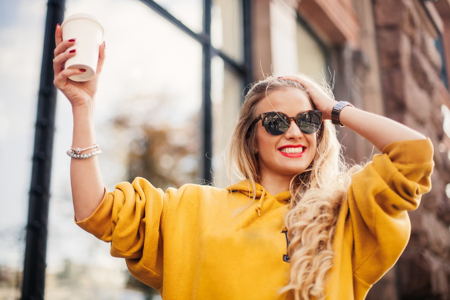 Happy woman holding coffee - Dental Crown in Georgetown