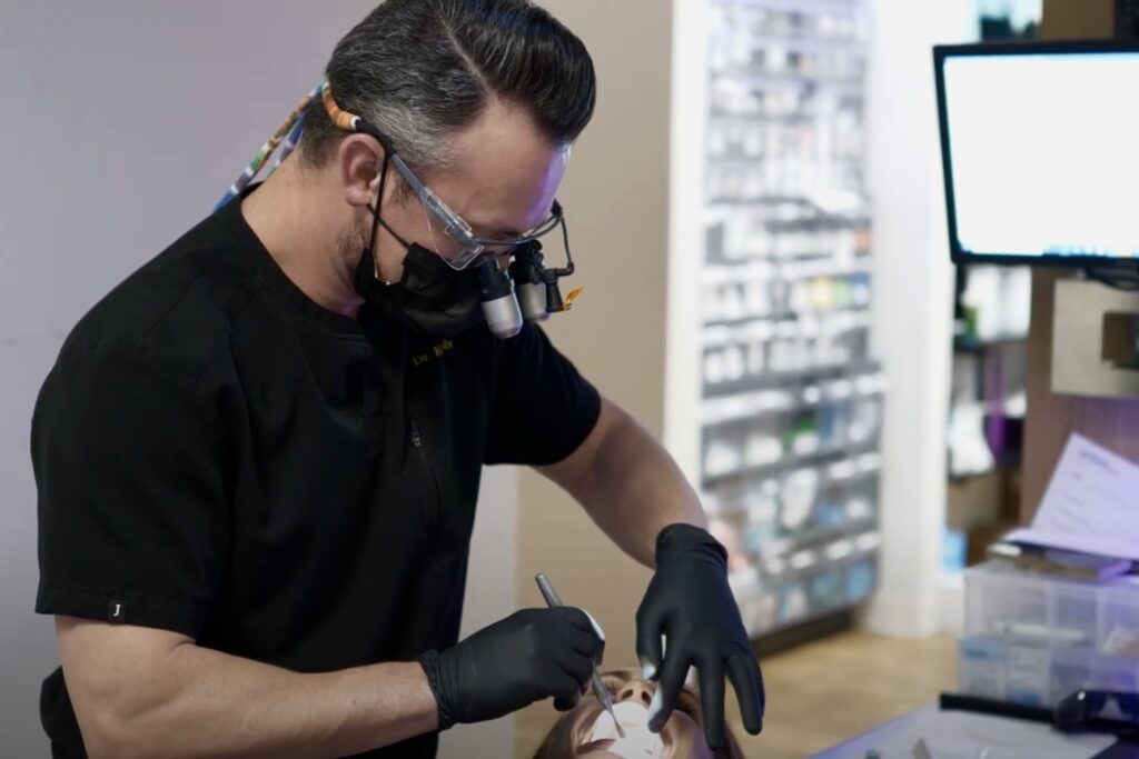 Dr. Andrew Edmonds examining a patient's mouth - Dentist Georgetown TX Dr. Andrew Edmonds examining a patient's mouth - Dentist Georgetown TX